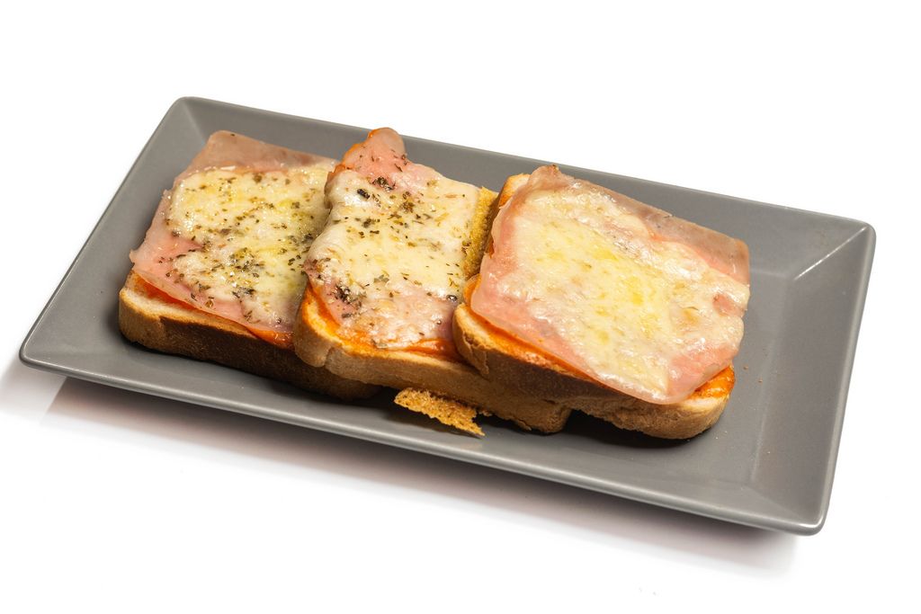 Served baked Toast Sandwiches with ham and cheese on the plate