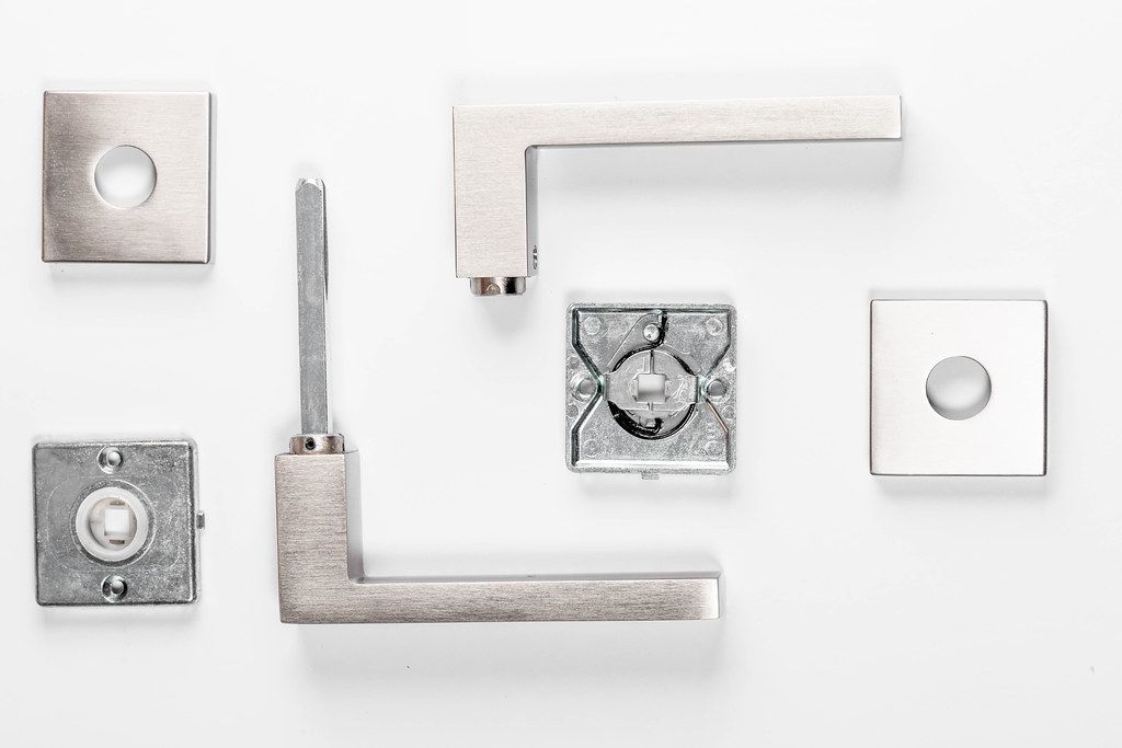Set of parts to door handle on white background (Flip 2019)