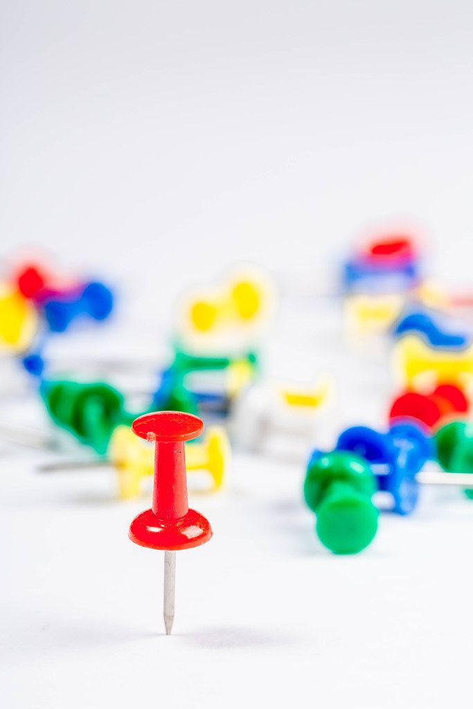 Set of push pins in different colors on white background (Flip 2019)