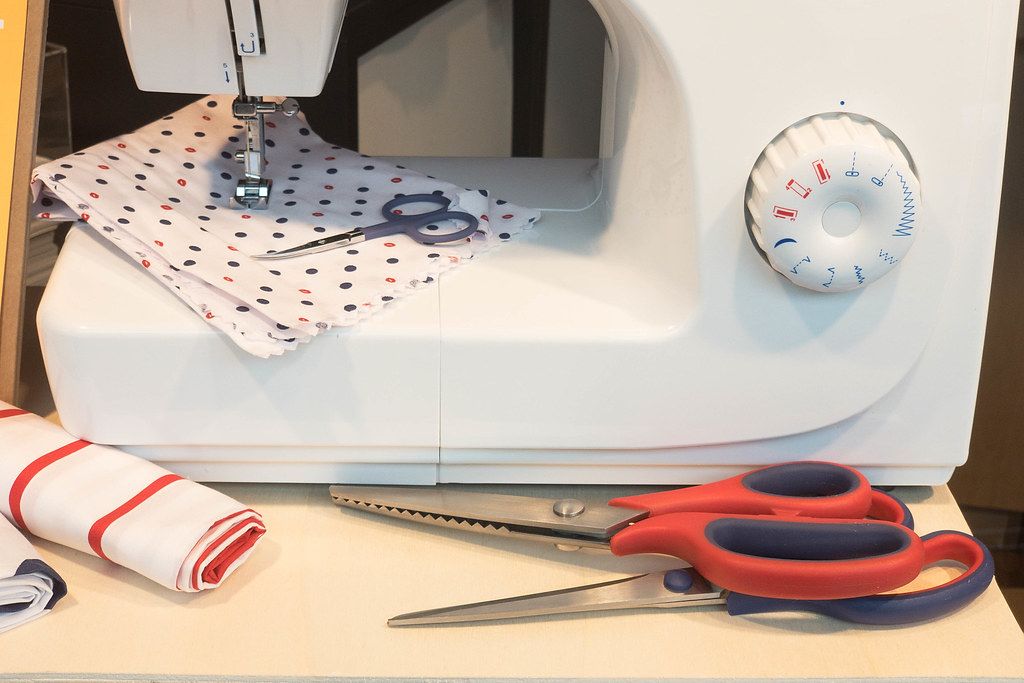 Sewing machine with sewing tools, three types of scissors and textiles