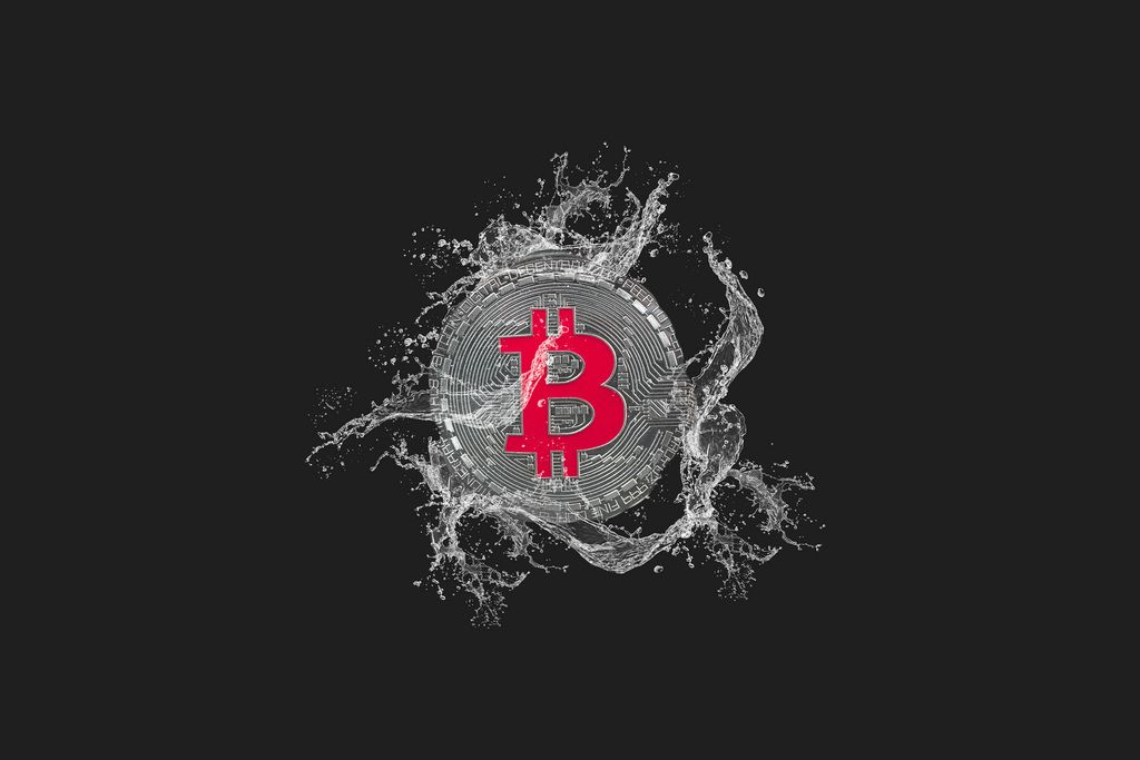 Silver Bitcoin and water splash on dark background