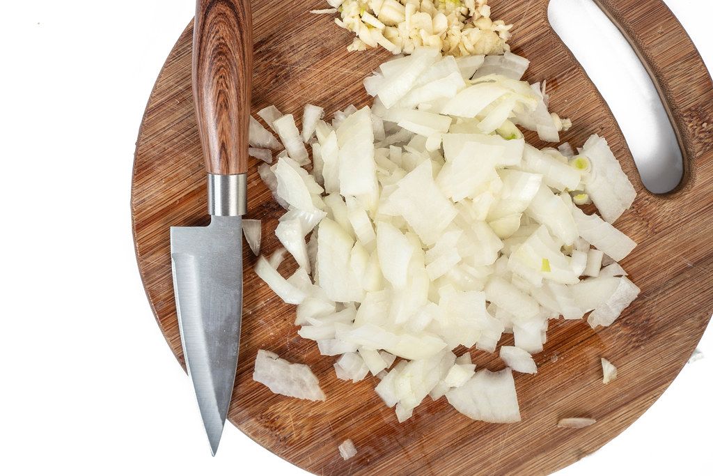 Sliced Onions with Garlic on the wooden cutting board