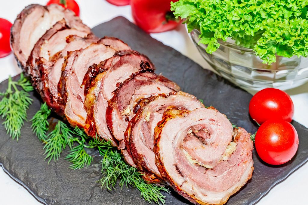 Sliced pieces of meatloaf with cherry tomatoes