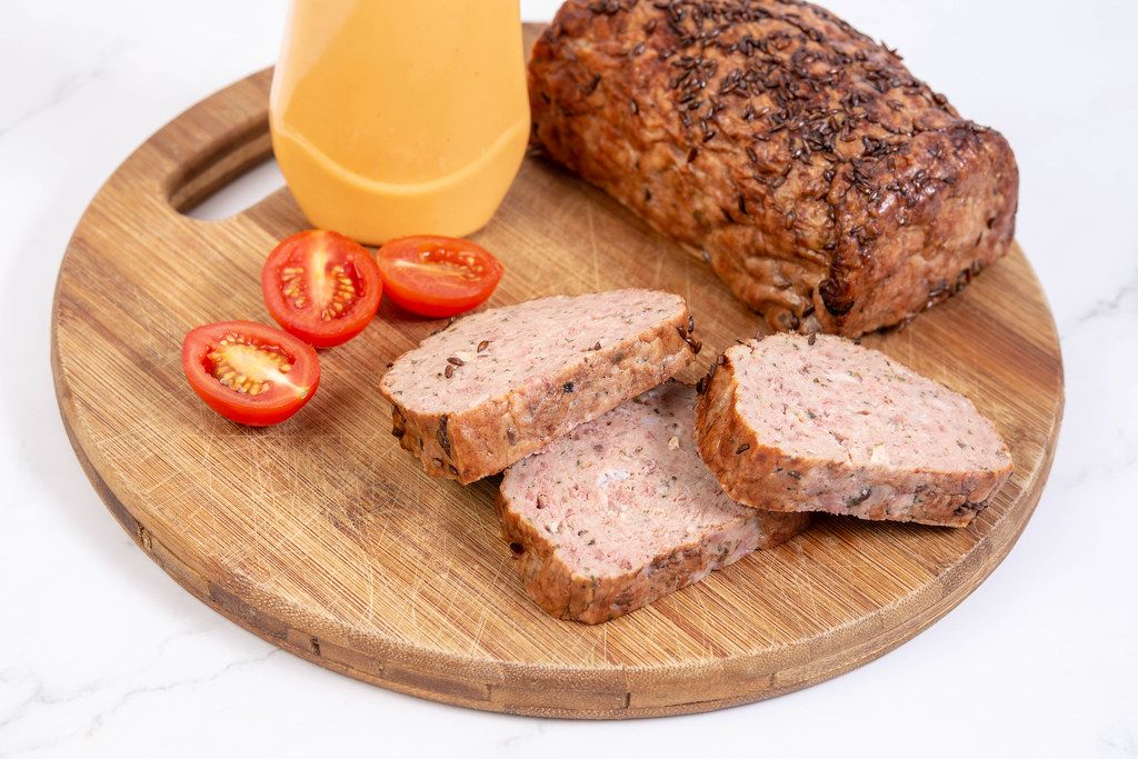 Sliced Pork and Chicken Meat Loaf with Tomatoes on the board