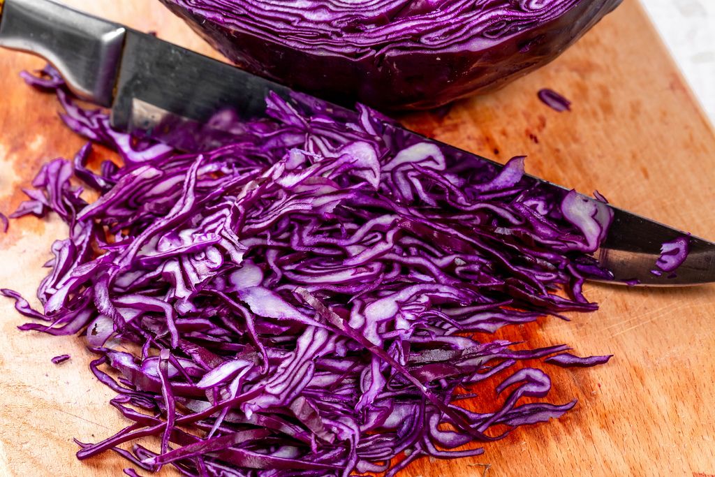 Sliced purple cabbage on kitchen Board