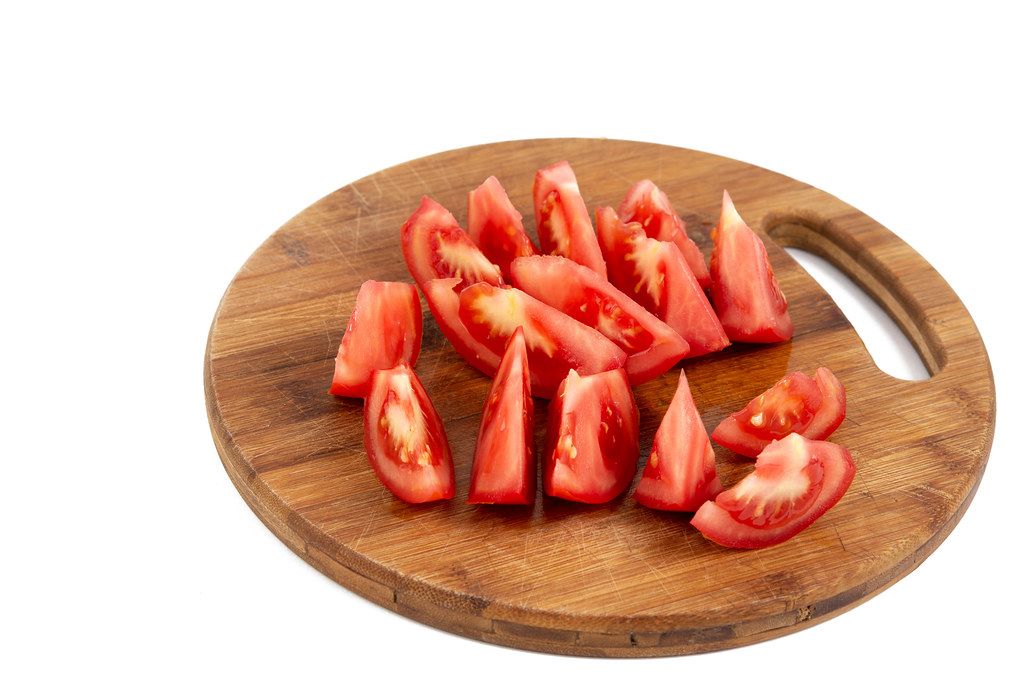 Crispbread And A Whole Tomato On A Wooden Cutting Board Creative 