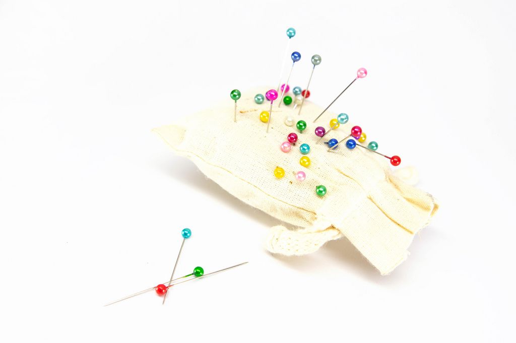 Small pillow with many colorful sewing pins inserted into it (Flip 2019) (Flip 2019) Flip 2019