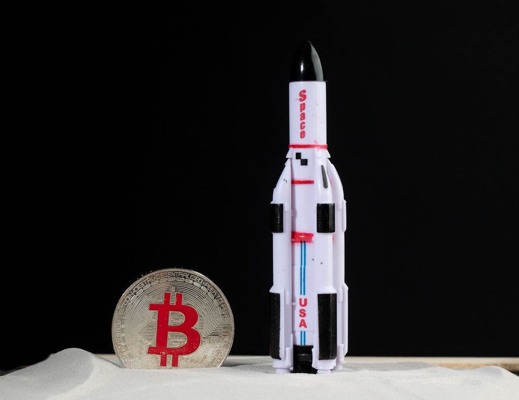 Space rocket with silver Bitcoin