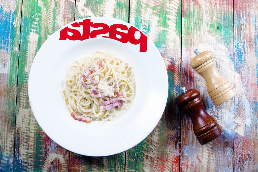 Spaghetti carbonara with bacon and parmesan, pasta plate, wooden background (Flip 2019)