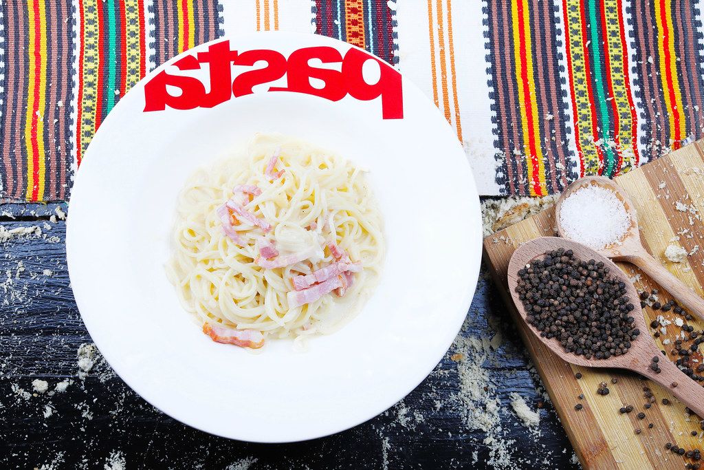 Spaghetti carbonara with peppercorns and salt, Italian cuisine (Flip 2019)