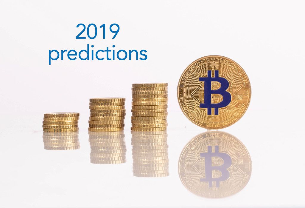Stack of gold coins with golden Bitcoin and 2019 predictions text