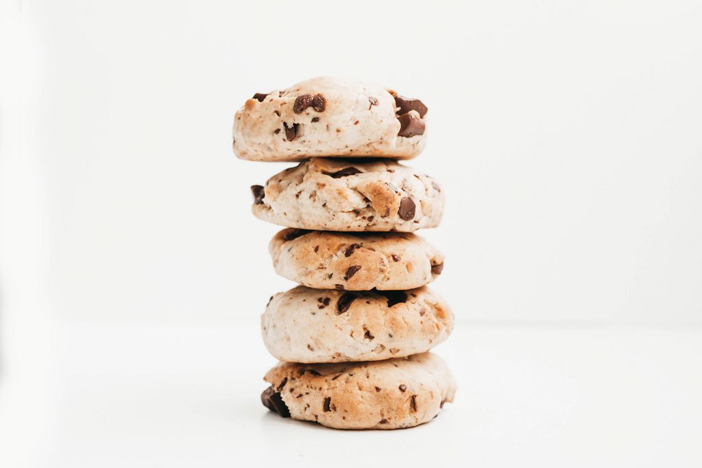 Stack of homemade vegan chocolate chip cookies on white background