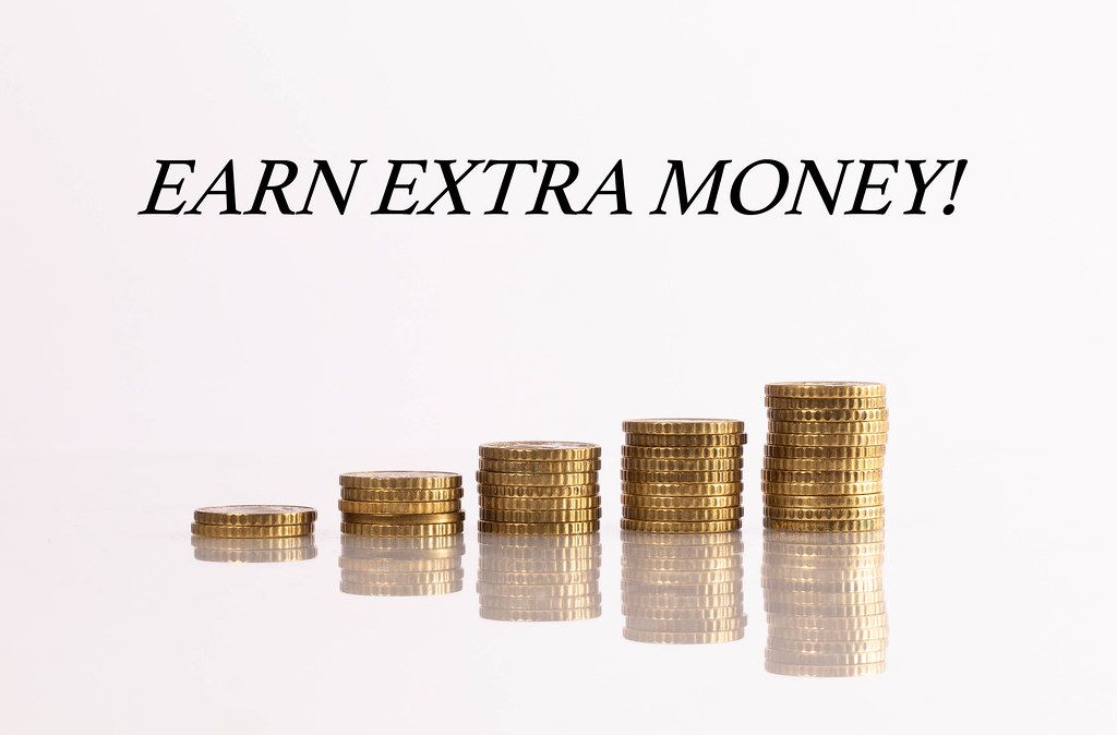 Stacks of coins with Earn extra money text