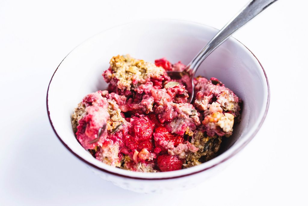 Strawberry and nuts baked oatmeal in a bowl on white background
