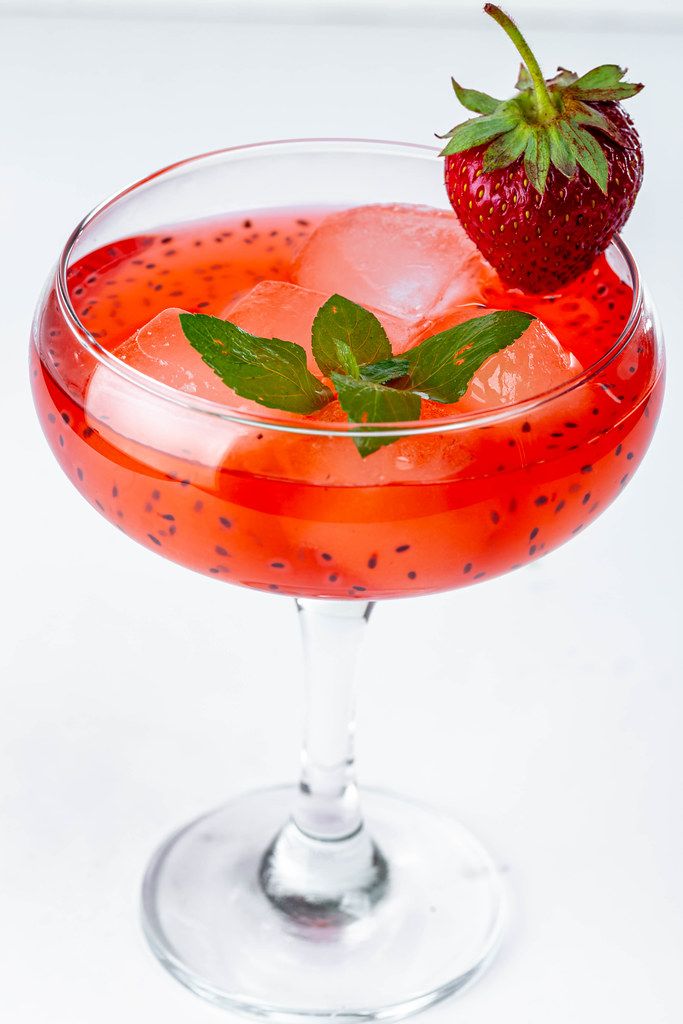Strawberry cocktail with ice cubes and mint leaves