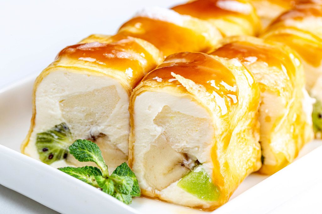 Sweet rolls with cheese, fruit and mint leaves