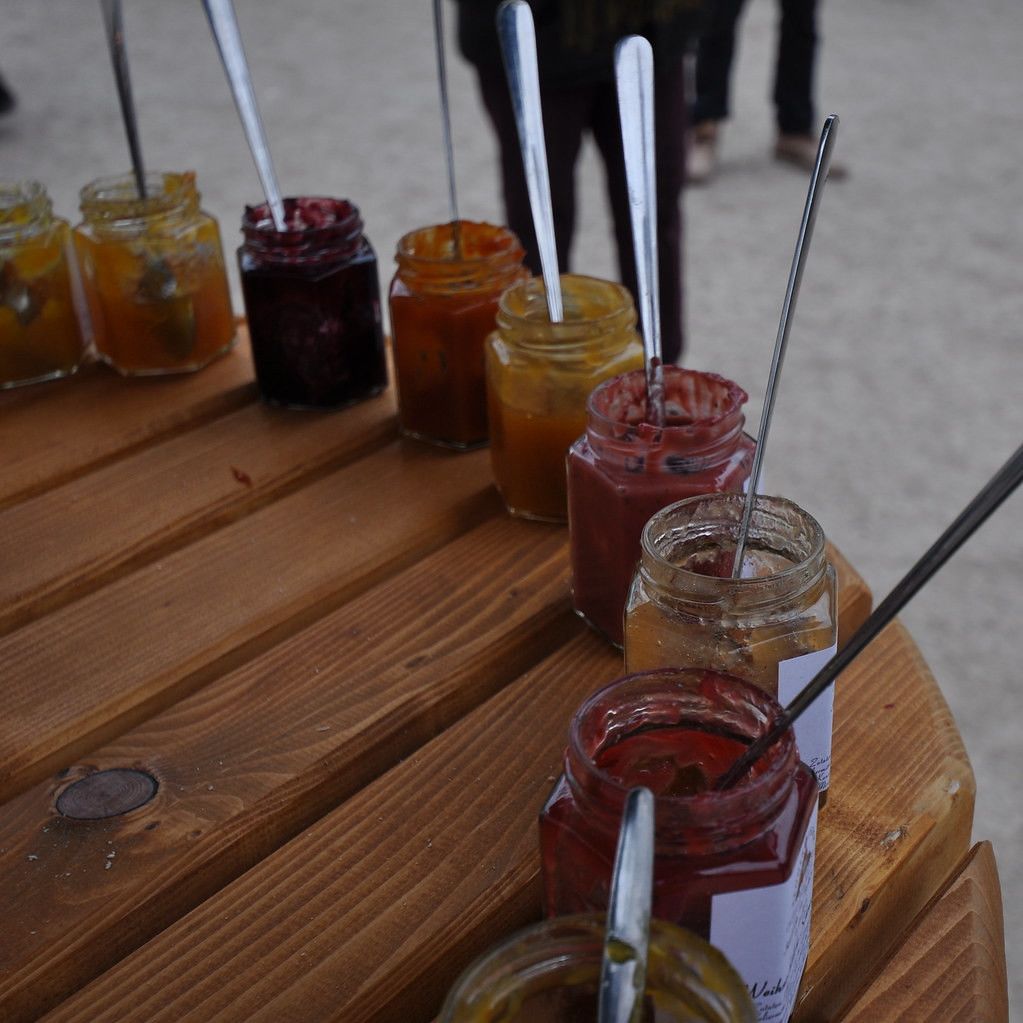 Table of Jars with Different Jams on a Wooden Table at a Market