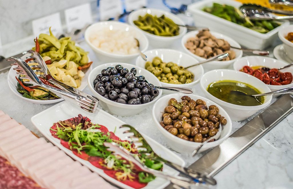 Table Served With Olives And Vegetables