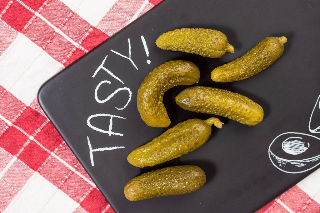 Tasty pickles on the black tray