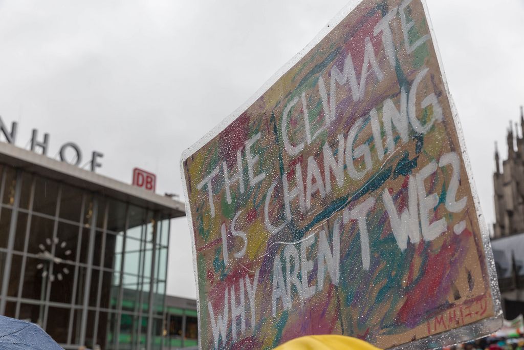 'The climate is changing, why aren't we?' sign for the global protection of the environment