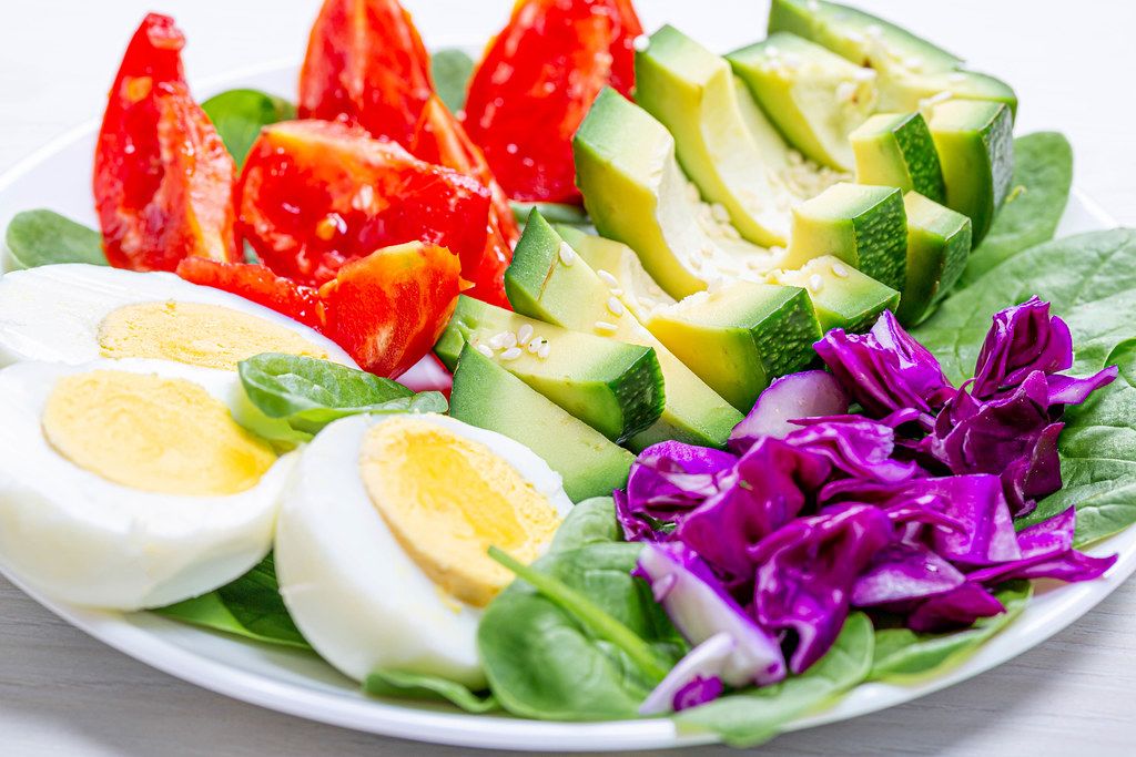 The concept of dietary nutrition. Boiled eggs with fresh vegetables
