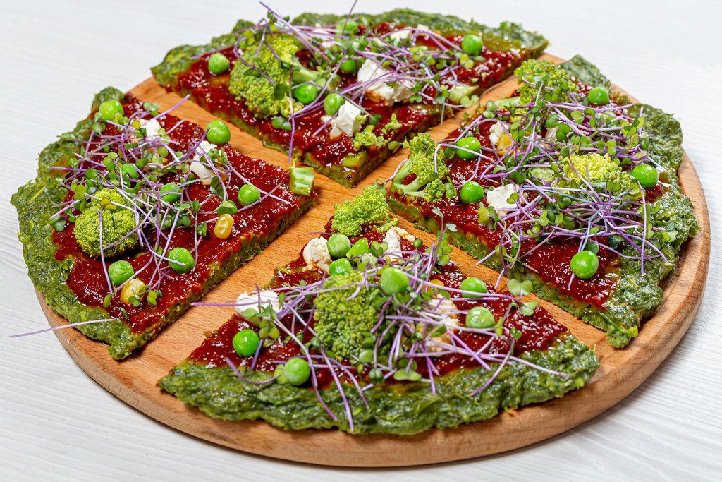 The concept of healthy food. Pizza with vegetables and micro greens cabbage (Flip 2019)