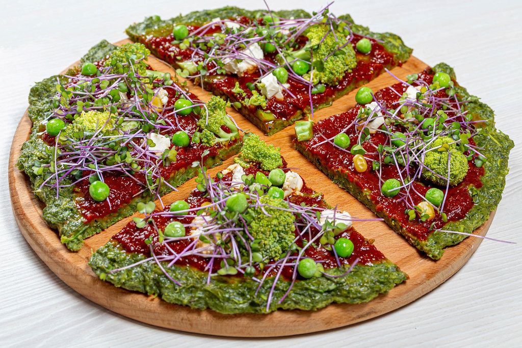 The concept of healthy food. Pizza with vegetables and micro greens cabbage