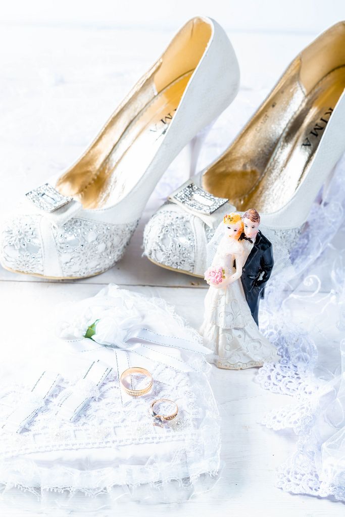 The concept of preparation for the wedding with white shoes and gold rings
