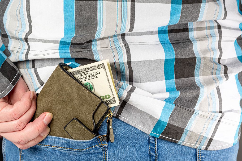 The man puts a wallet with money in his pocket