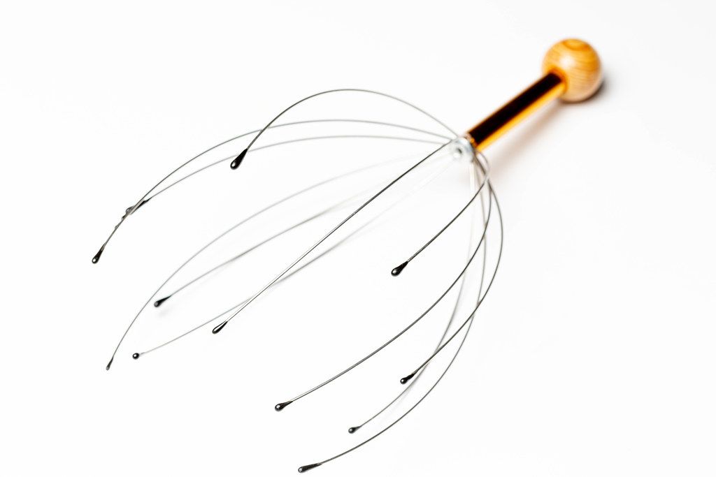 The manual head massager on white background