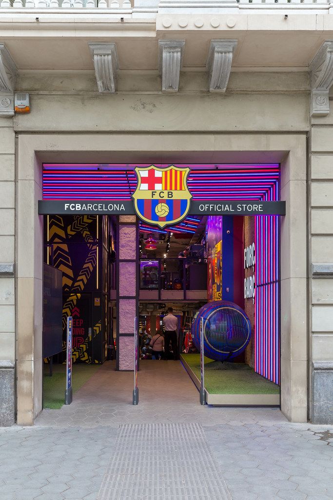 The official FC Barcelona Store shines in club colors of the Spanish soccer team, near Jardins de la Reina Victòria in Spain