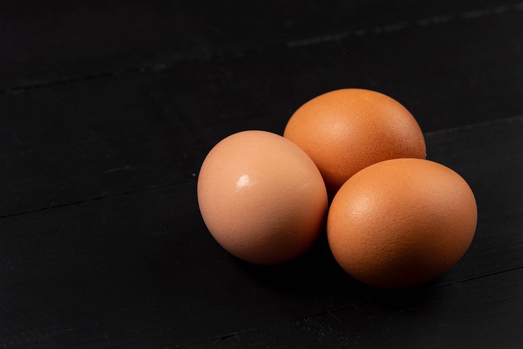 Three Chicken Eggs on the black background