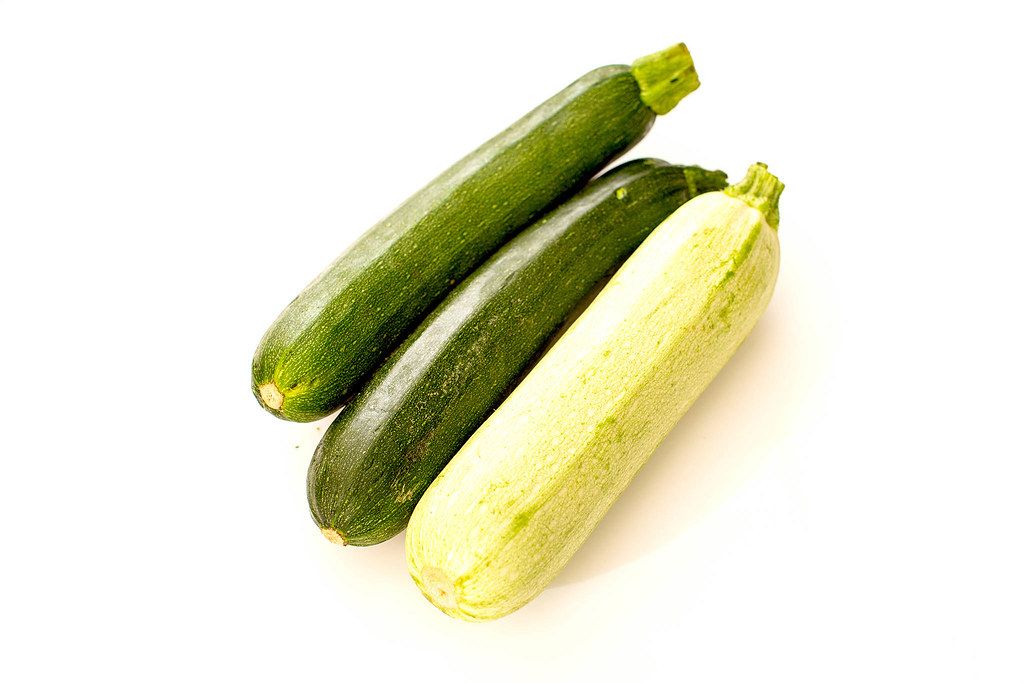 Three raw green zucchini on white background (Flip 2019)