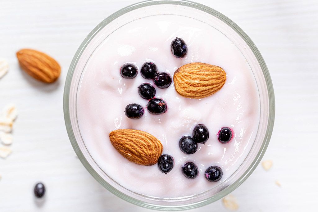 Top-view-black-elderberry-and-almond-nuts-with-yogurt-on-oatmeal.jpg