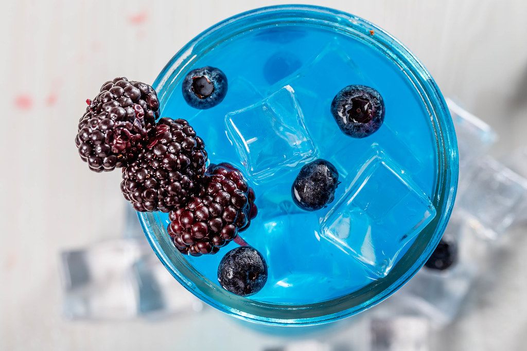 Top view, cocktail with ice cubes, mulberry and blueberry (Flip 2019 ...