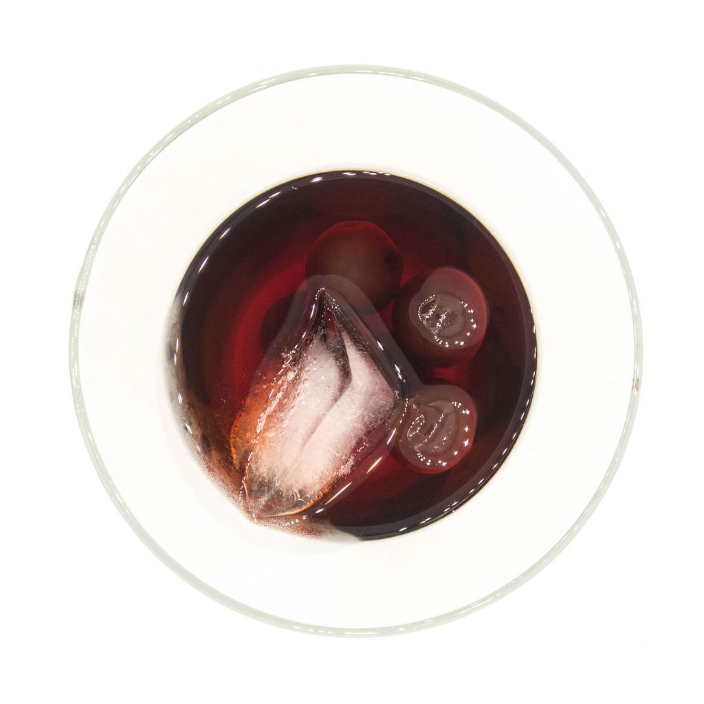 Top view of cherry brandy with cherries and ice