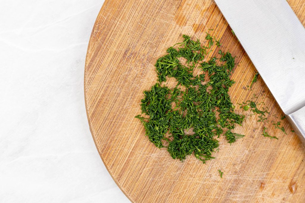 Top view of Chopped Parsley on the wooden board
