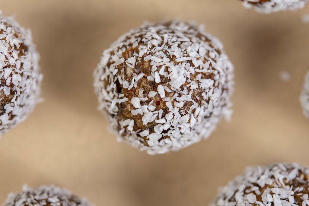 Top view of Dates and Peanut Butter energy balls in the Coconut