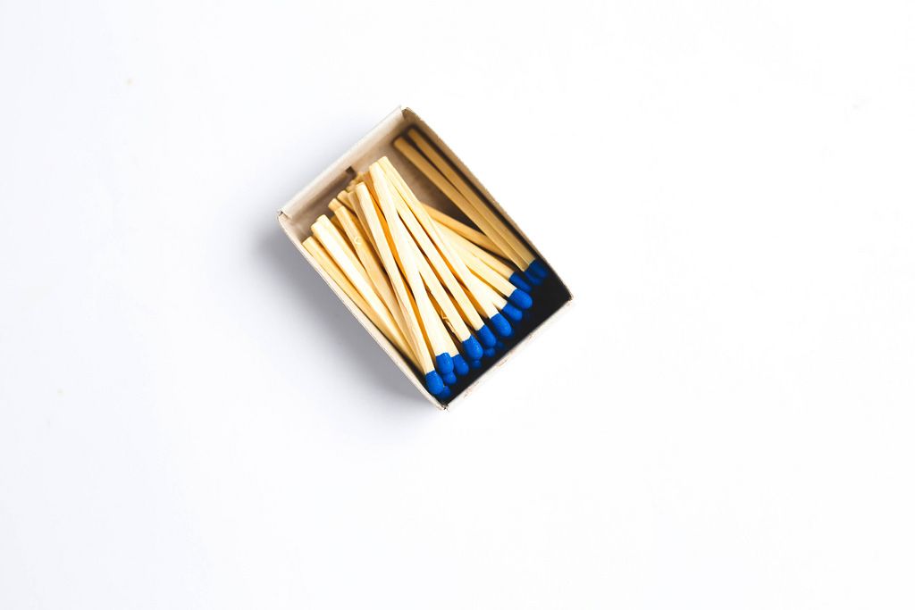 Top view of pack of blue matches on white background