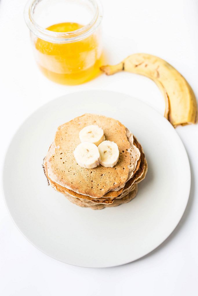 Top view of stacked vegan pancakes with honey and banana (Flip 2019) (Flip 2019) Flip 2019
