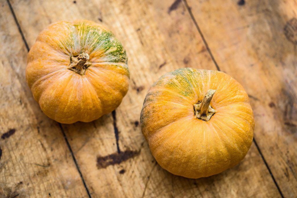 Top View Photo of two Pumpkins on Wooden Table