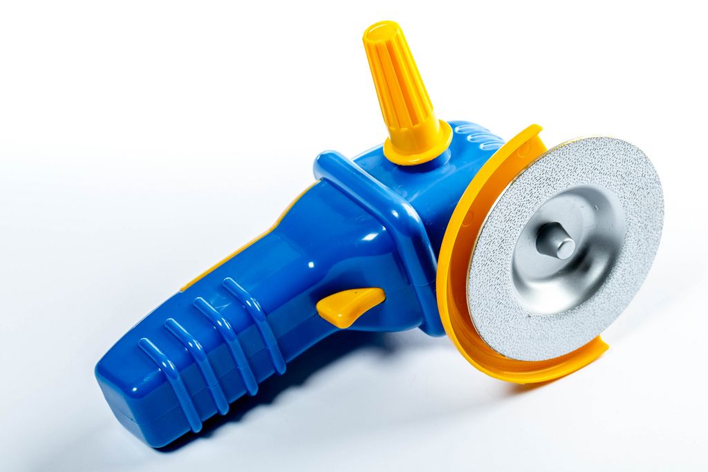 Toy plastic grinding tool on white background (Flip 2019)