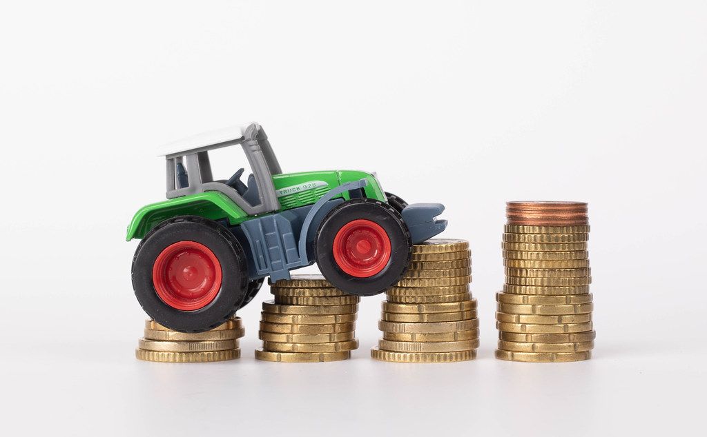 Tractor on coin stacks