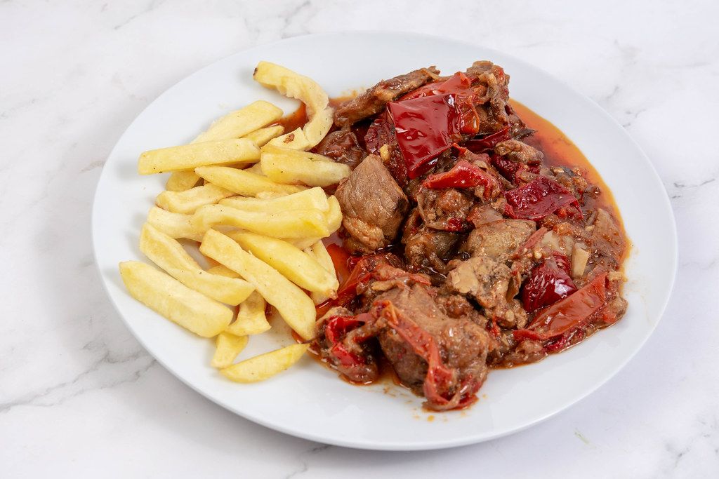 Traditinal meal Muckalica with Pork Meat and French Fries