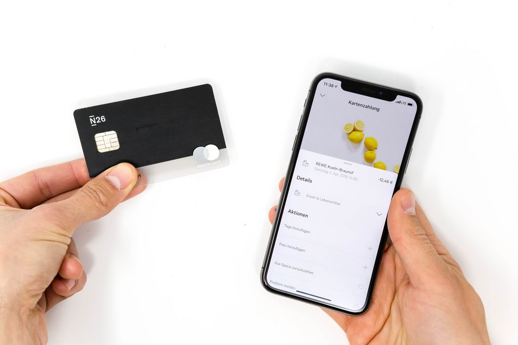 Transparent black N26 bank card and card payment details shown in the N26 mobile app on an iPhone