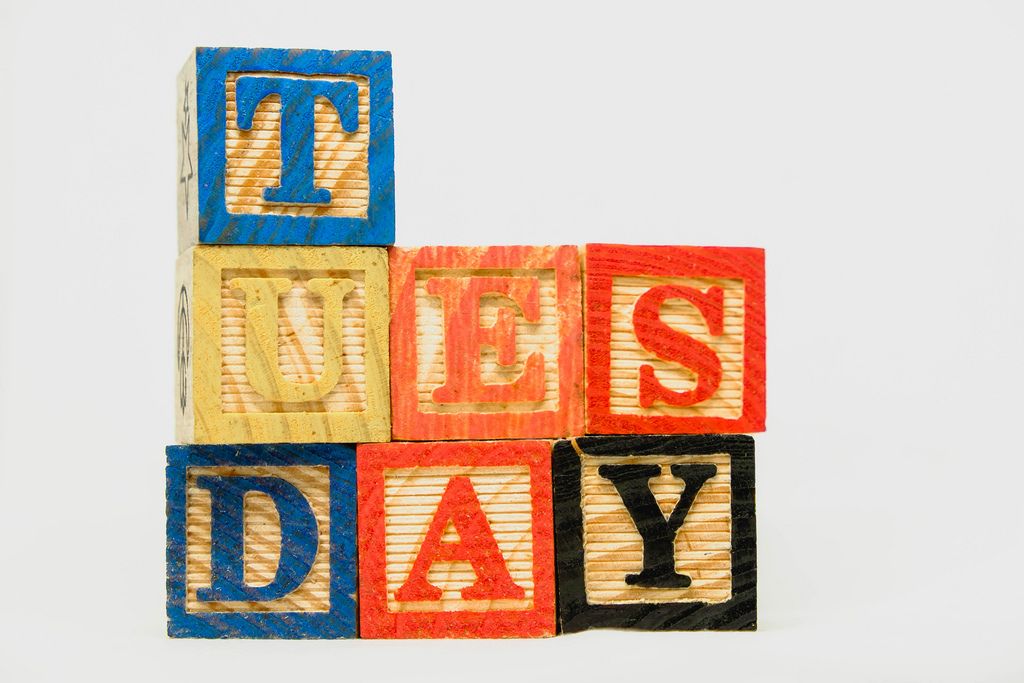 Tuesday text on wooden blocks on white background