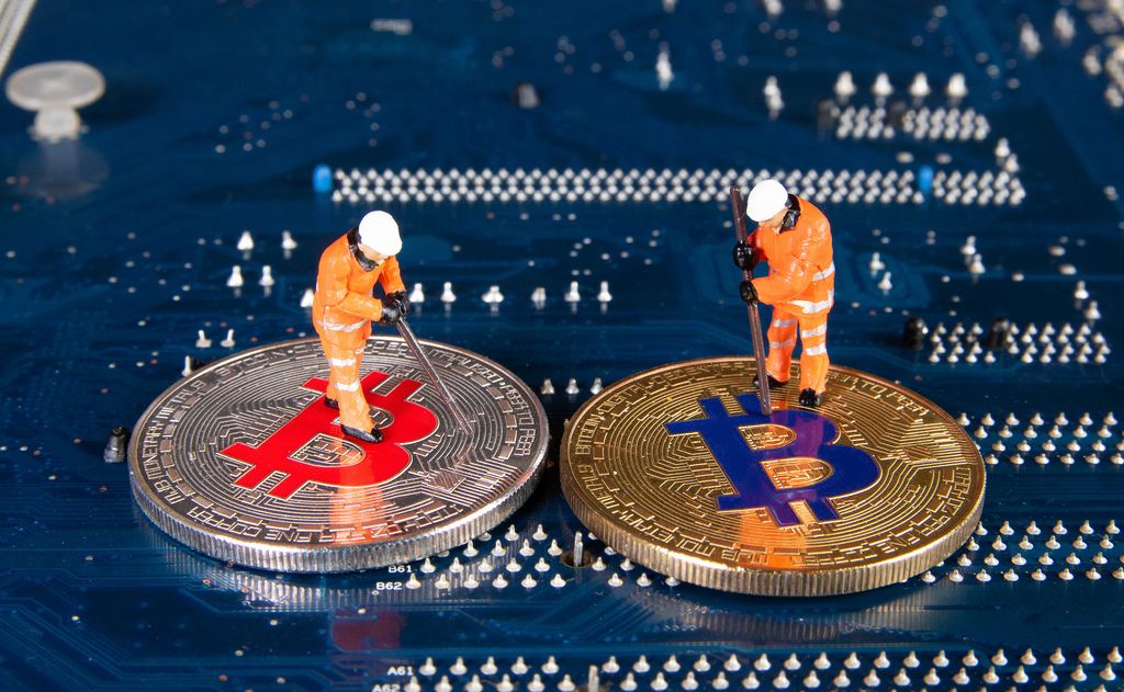 Two miners figures standing on a Bitcoins