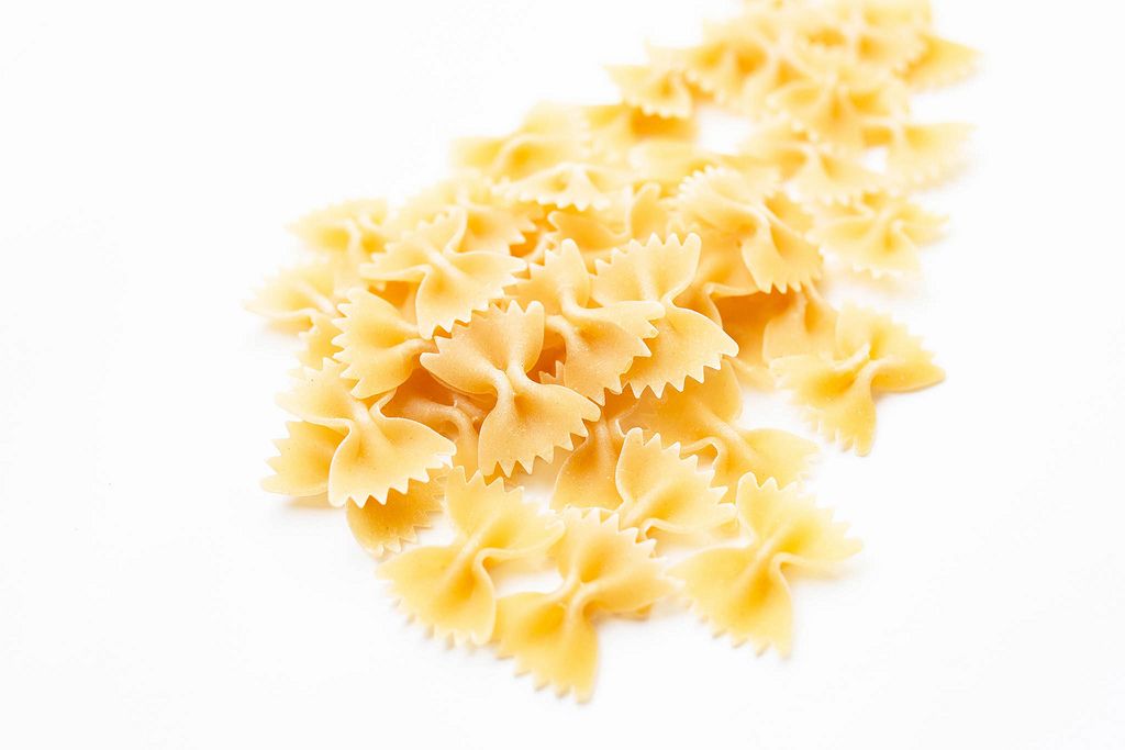 Uncooked dry farfalle pasta isolated on white background (Flip 2019) (Flip 2019) Flip 2019
