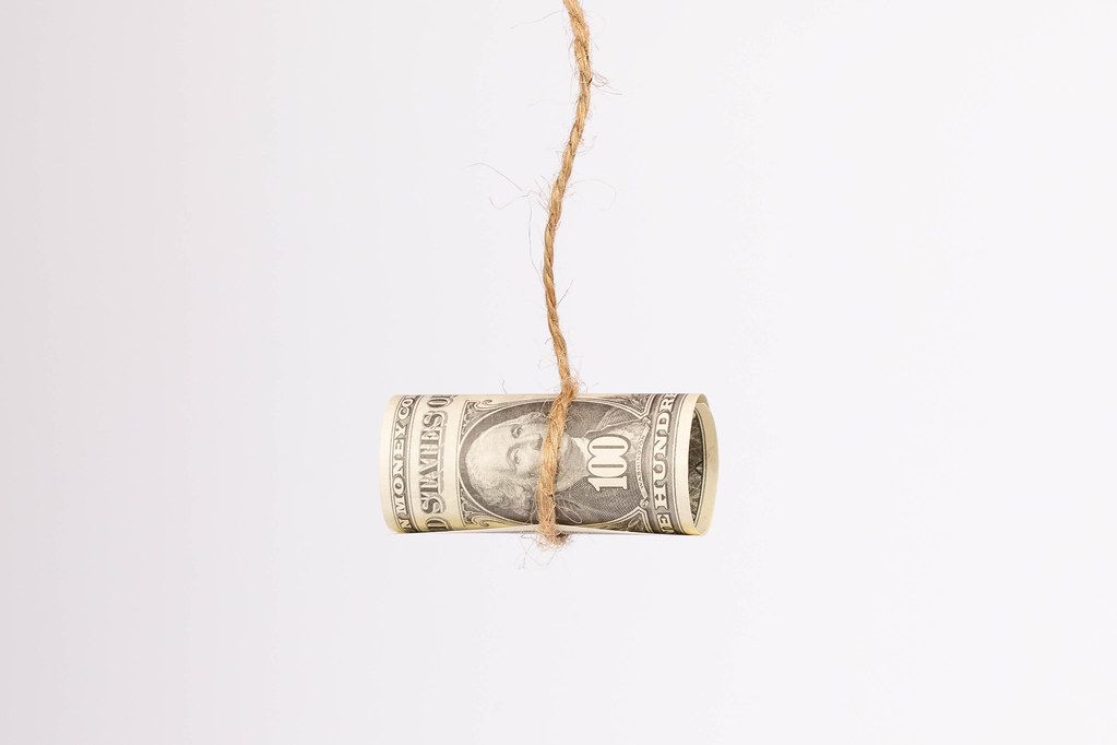 US dollar held by a rope isolated on white background