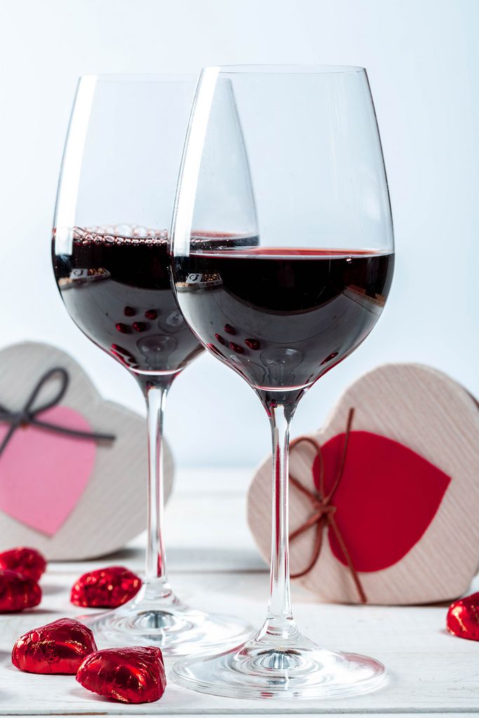 Valentine's day background with red wine and gift boxes